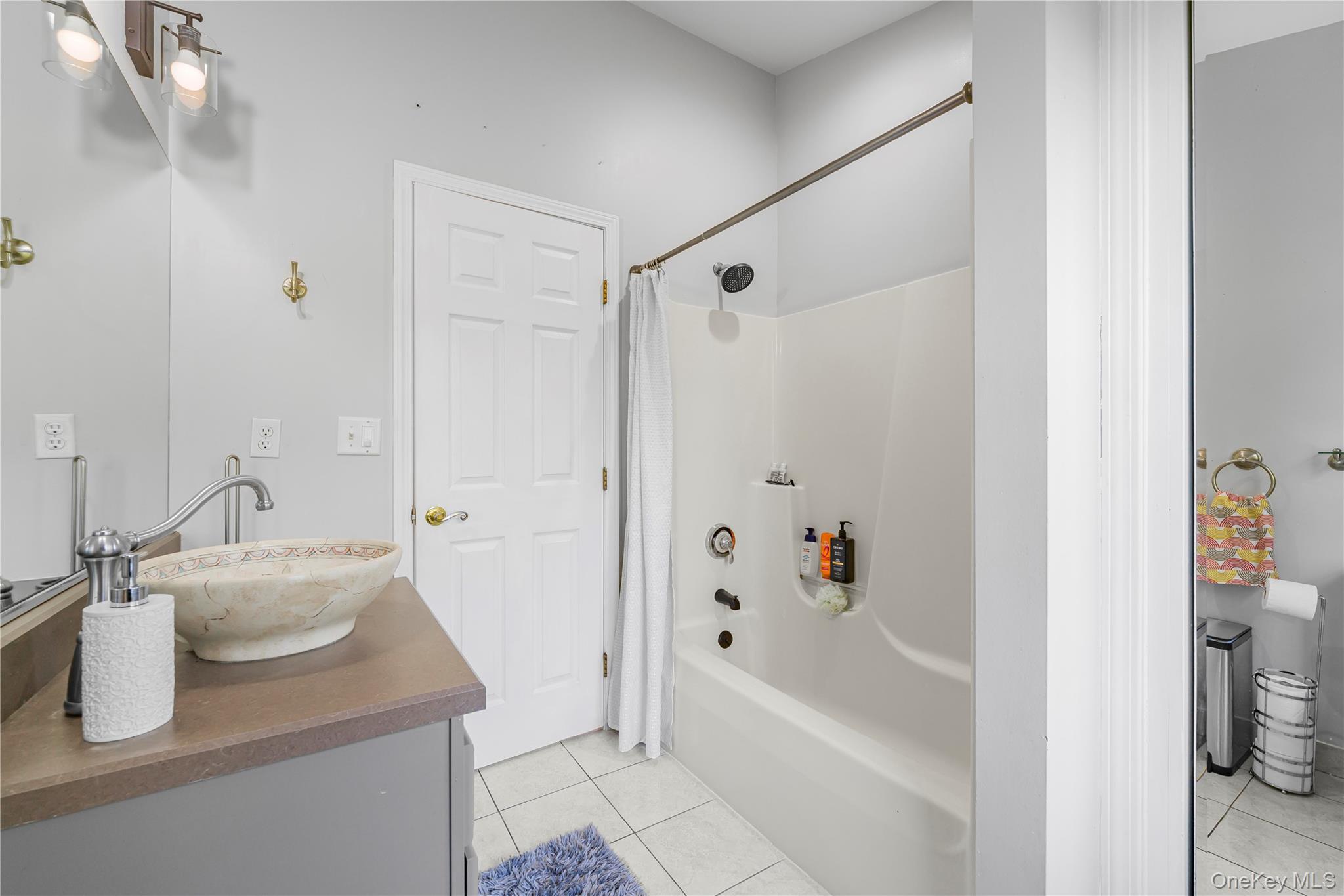 17 Brendella Court Wallkill, NY 12589 - Photo 21 of 42 Full bathroom with light tile patterned flooring, shower / bathtub combination with curtain, and vanity