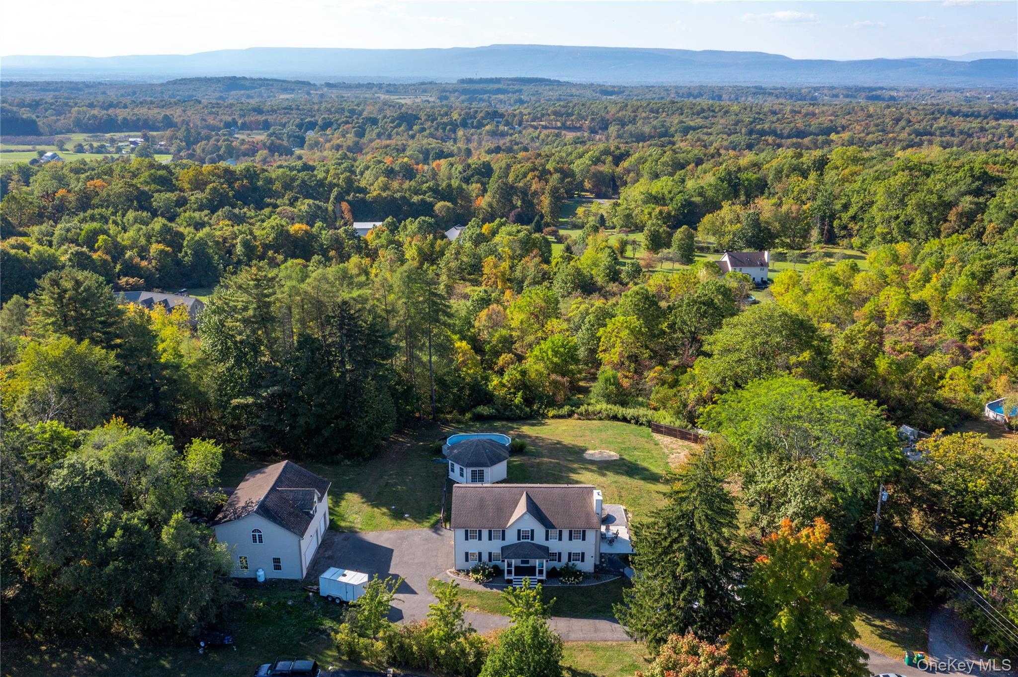 17 Brendella Court Wallkill, NY 12589 - Photo 38 of 42 Aerial view of property and surrounding area featuring a heavily wooded area and mountains