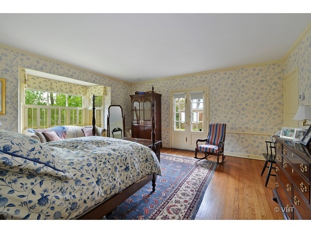 88 Locust Road Winnetka, IL 60093 - Photo 14 of 25 a bedroom with a bed large window and chair