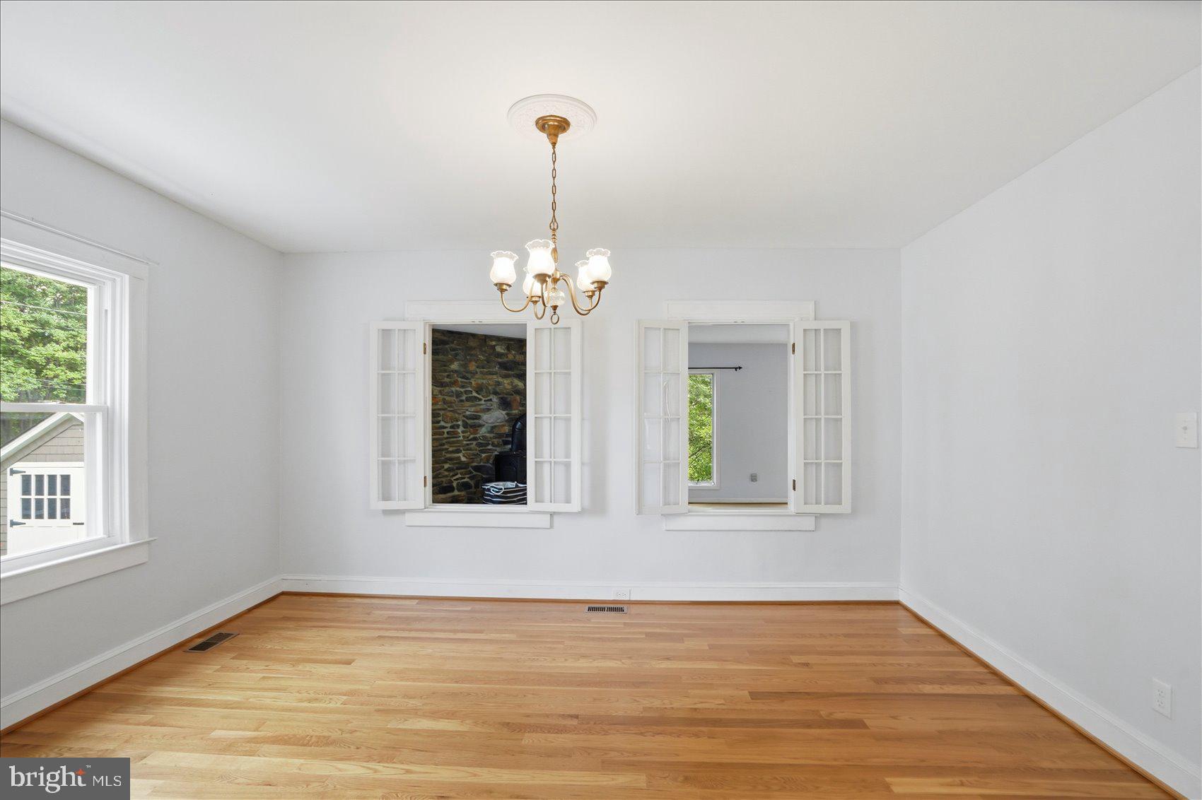 24 Normal Terrace Baltimore, MD 21286 - Photo 9 of 37 a view of an empty room with wooden floor and a window