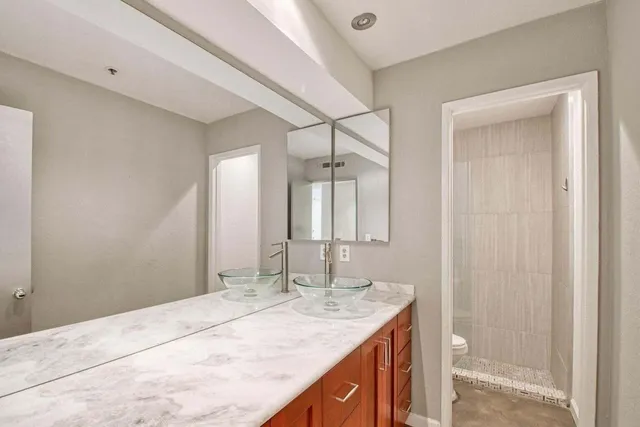 a bathroom with a granite countertop sink and a mirror