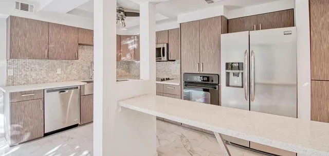 a kitchen with a refrigerator and a sink