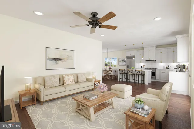 a living room with furniture and kitchen view