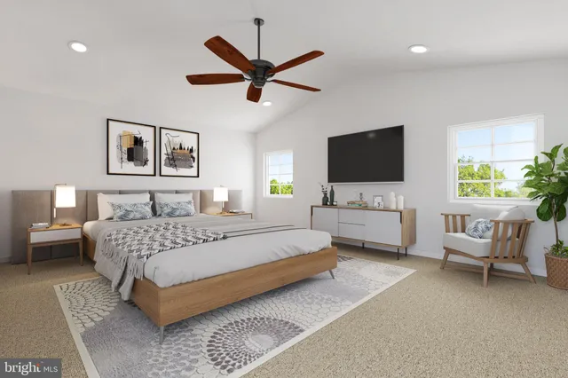 a spacious bedroom with a bed and a flat screen tv