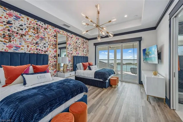 a bedroom with a bed and a large window with the outer view