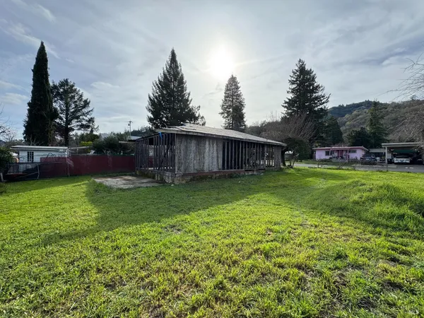 a view of a house with a backyard