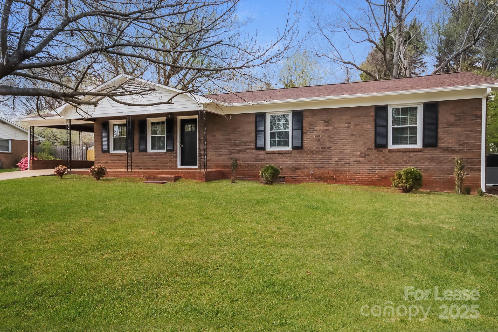 1135 Carolina Circle Statesville, NC 28677 - Photo 1 of 16 a front view of a house with a yard