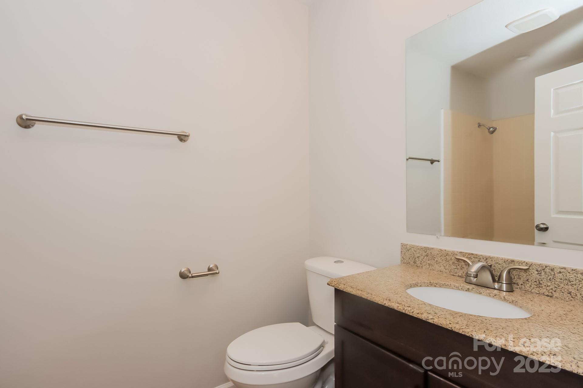 1135 Carolina Circle Statesville, NC 28677 - Photo 13 of 16 a bathroom with a granite countertop sink toilet and a mirror