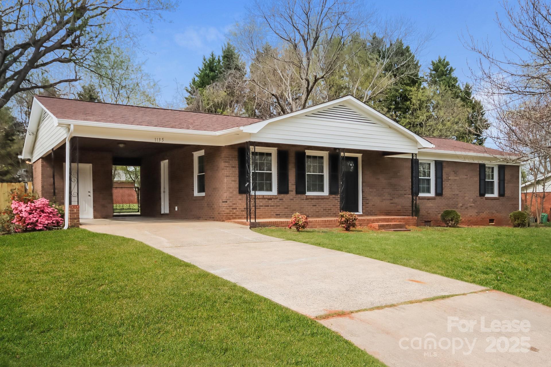 1135 Carolina Circle Statesville, NC 28677 - Photo 2 of 16 a front view of a house with a garden and porch