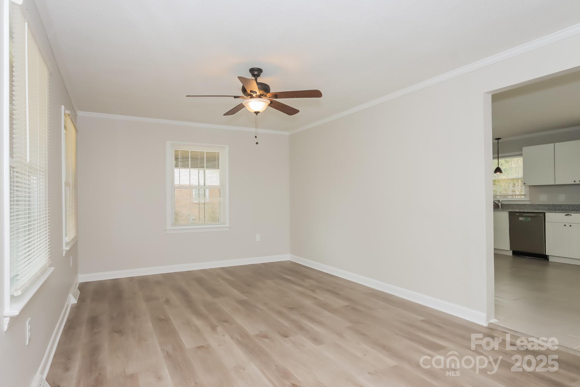 1135 Carolina Circle Statesville, NC 28677 - Photo 3 of 16 a view of empty room with wooden floor and fan