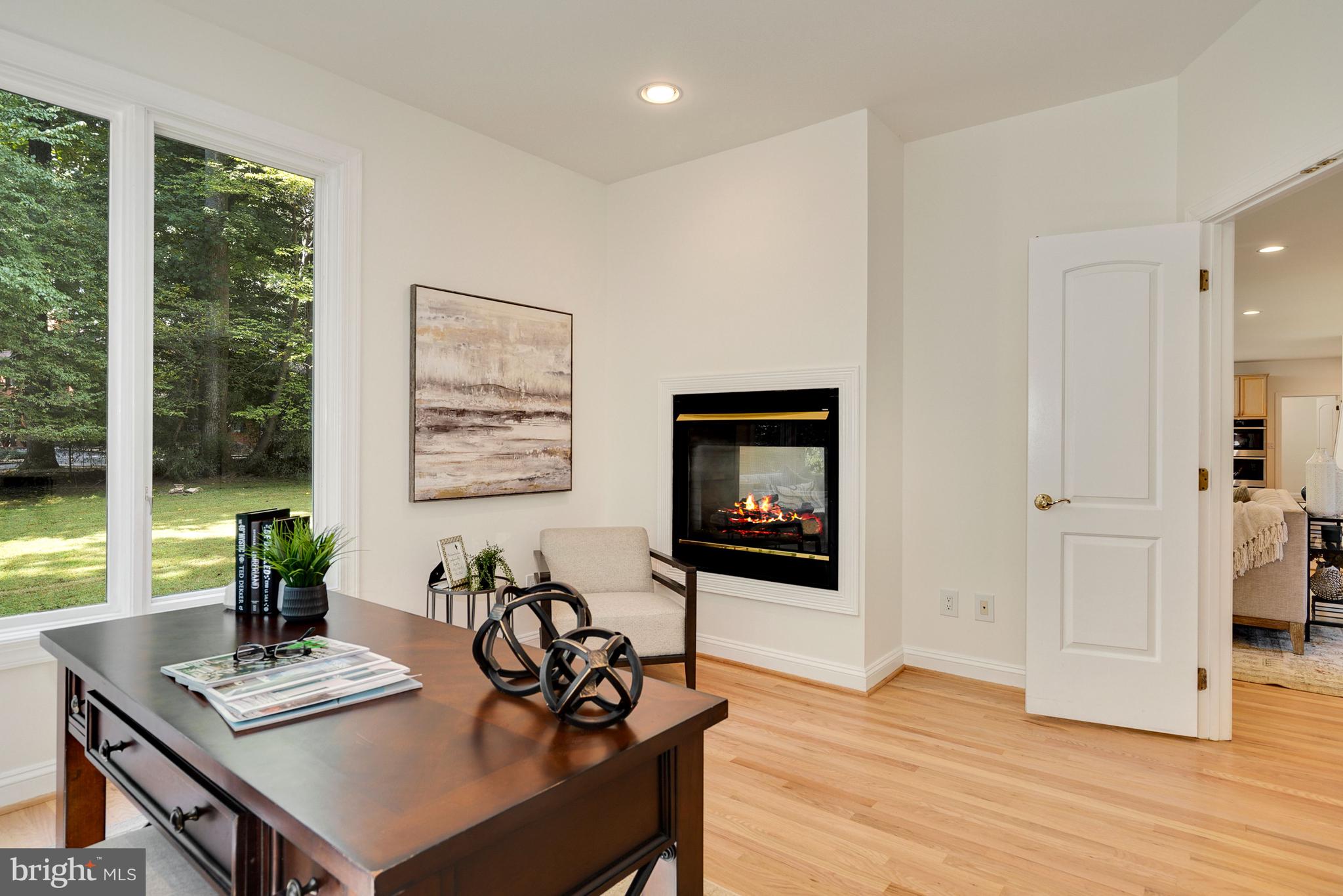 10121 Glen Road Potomac, MD 20854 - Photo 23 of 70 Den shares the double sided fireplace