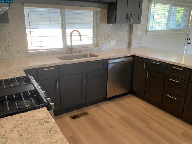 a kitchen with a sink and cabinets