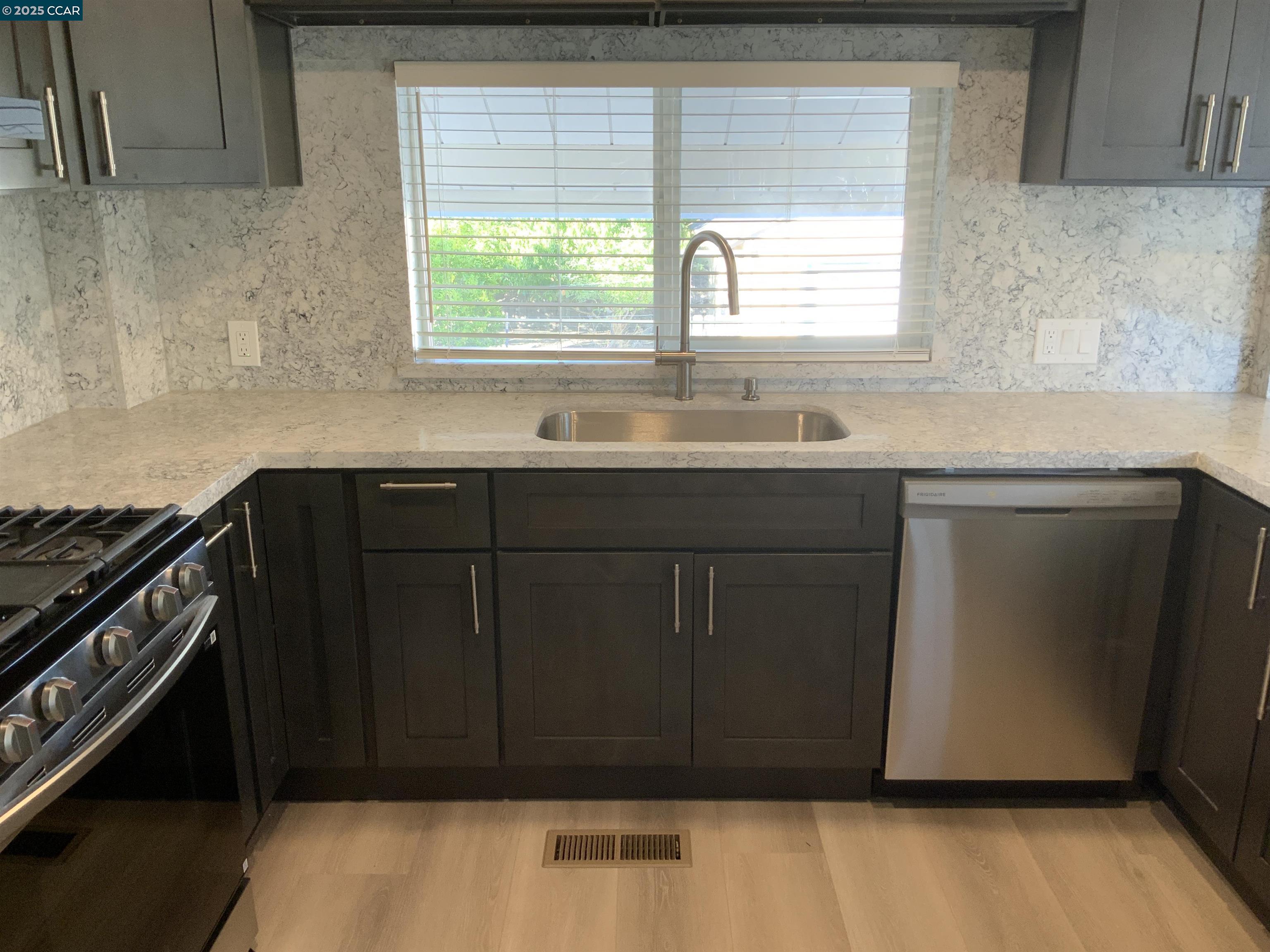 2680 Appian Way Pinole, CA 94564 - Photo 13 of 31 a kitchen with a sink wooden cabinets and a window