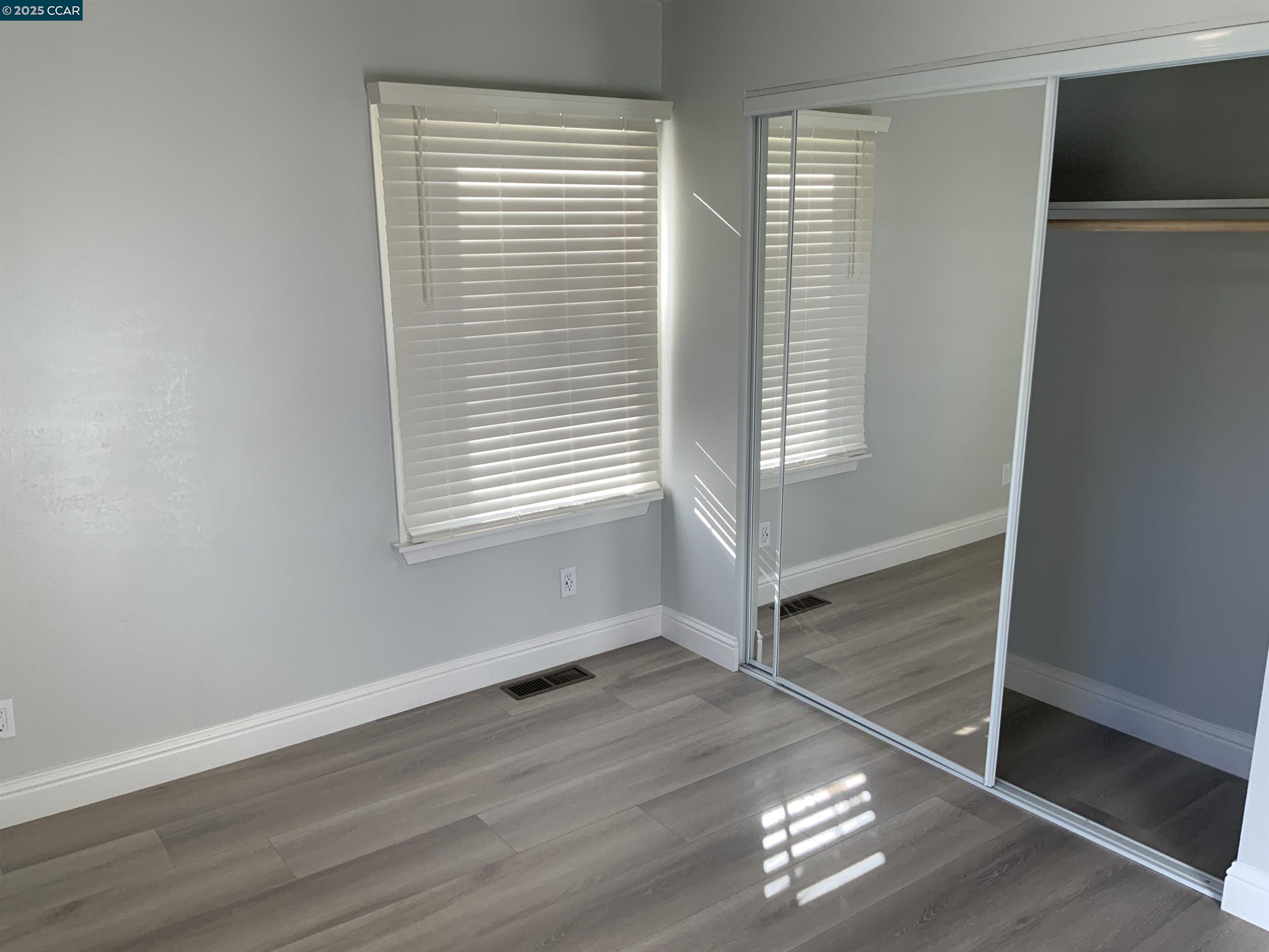 2680 Appian Way Pinole, CA 94564 - Photo 20 of 31 an empty room with wooden floor and windows