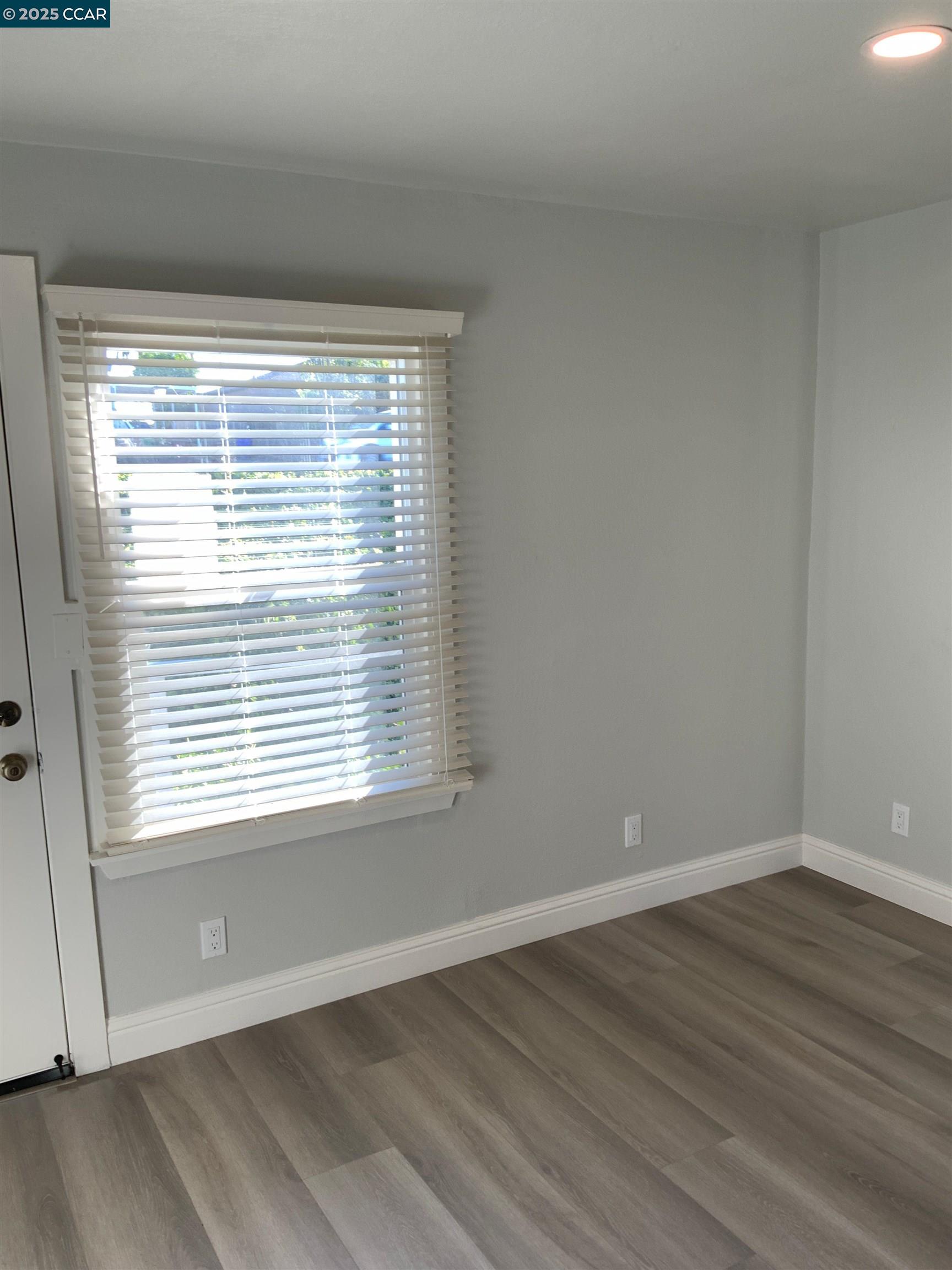 2680 Appian Way Pinole, CA 94564 - Photo 22 of 31 a view of an empty room with wooden floor and a window