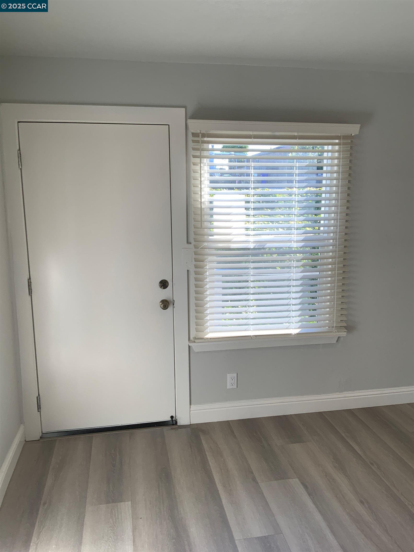 2680 Appian Way Pinole, CA 94564 - Photo 23 of 31 a view of an empty room with wooden floor and a window