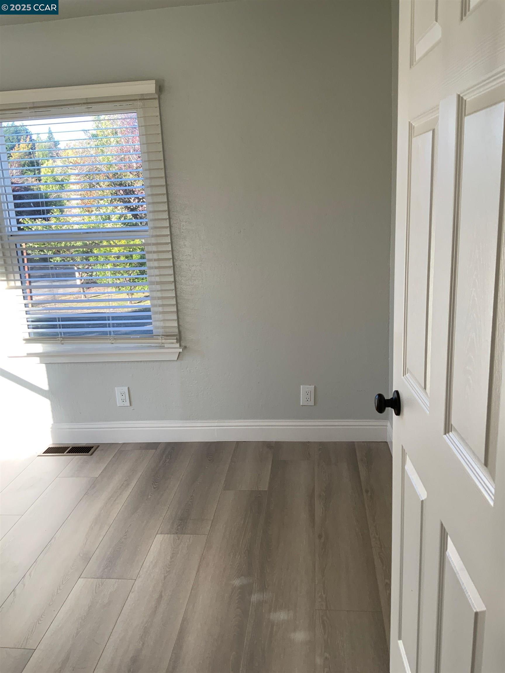 2680 Appian Way Pinole, CA 94564 - Photo 24 of 31 an empty room with wooden floor and windows