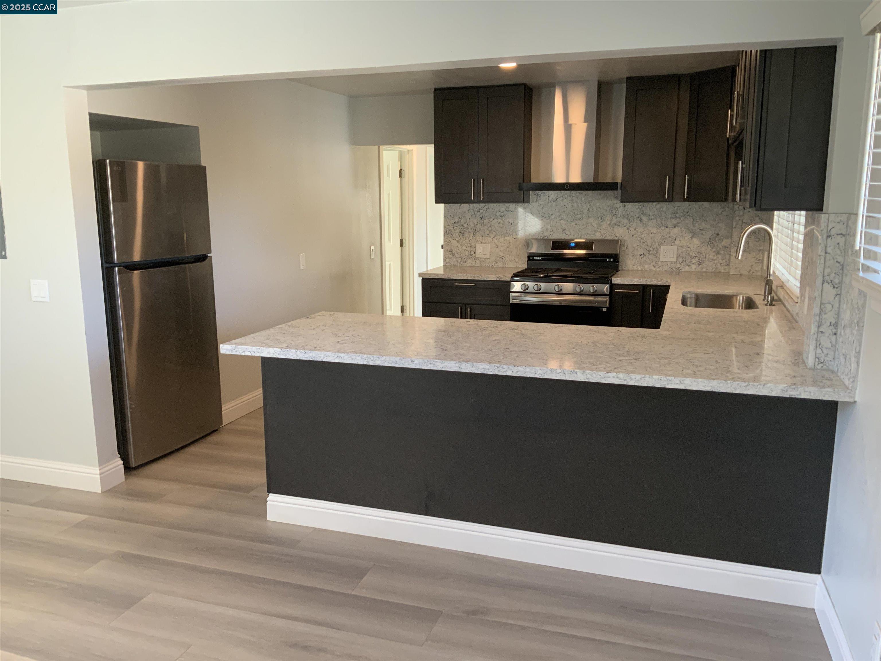 2680 Appian Way Pinole, CA 94564 - Photo 5 of 31 a kitchen with a refrigerator and a sink