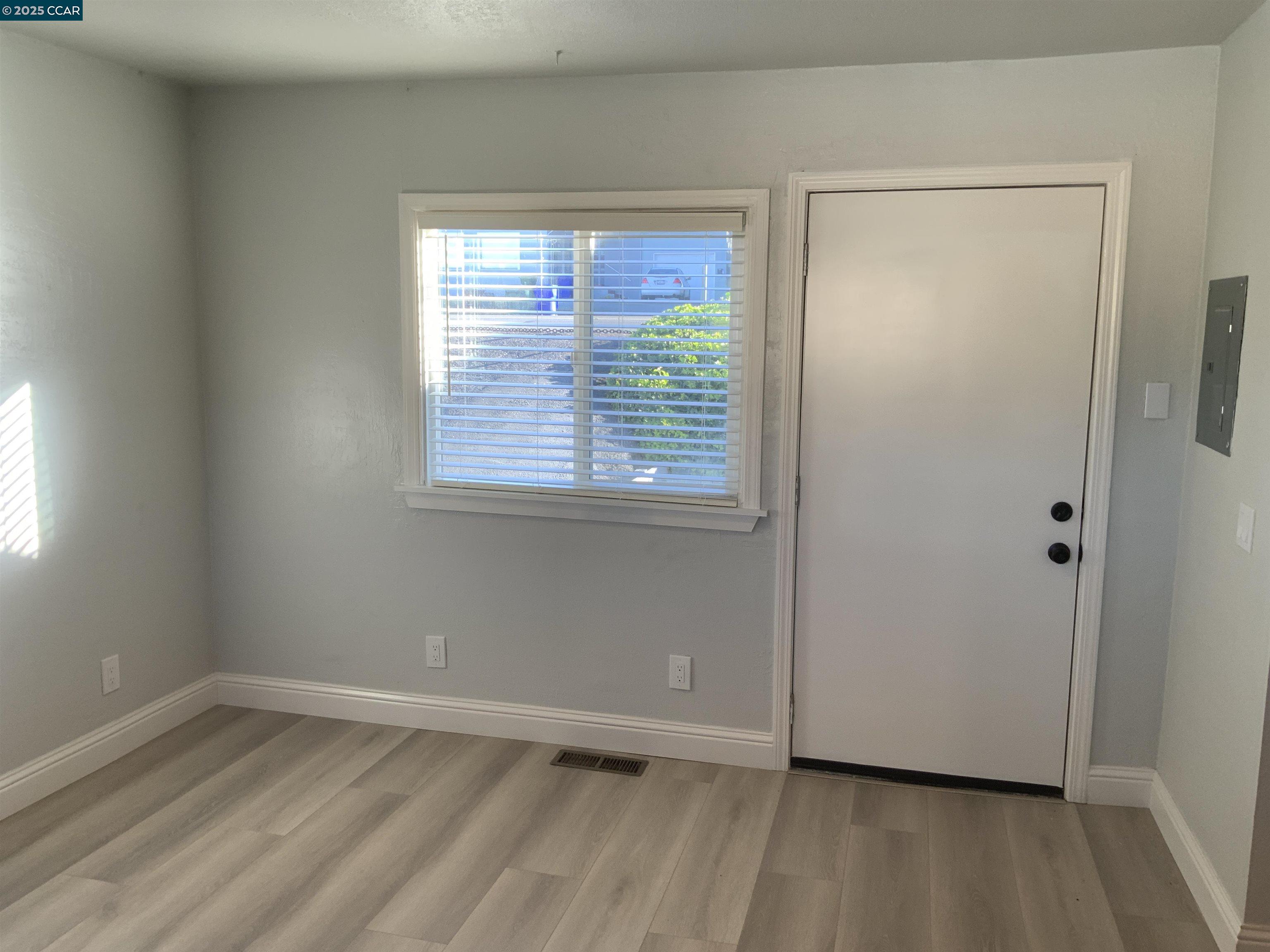 2680 Appian Way Pinole, CA 94564 - Photo 9 of 31 a view of an empty room with wooden floor and a window