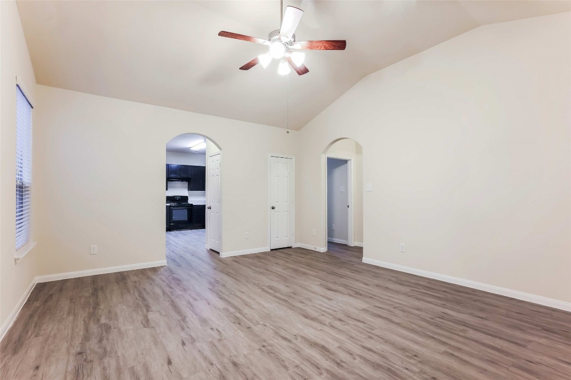12330 Roy Mix Bohn Lane Houston, TX 77044 - Photo 7 of 17 wooden floor in an empty room with a window