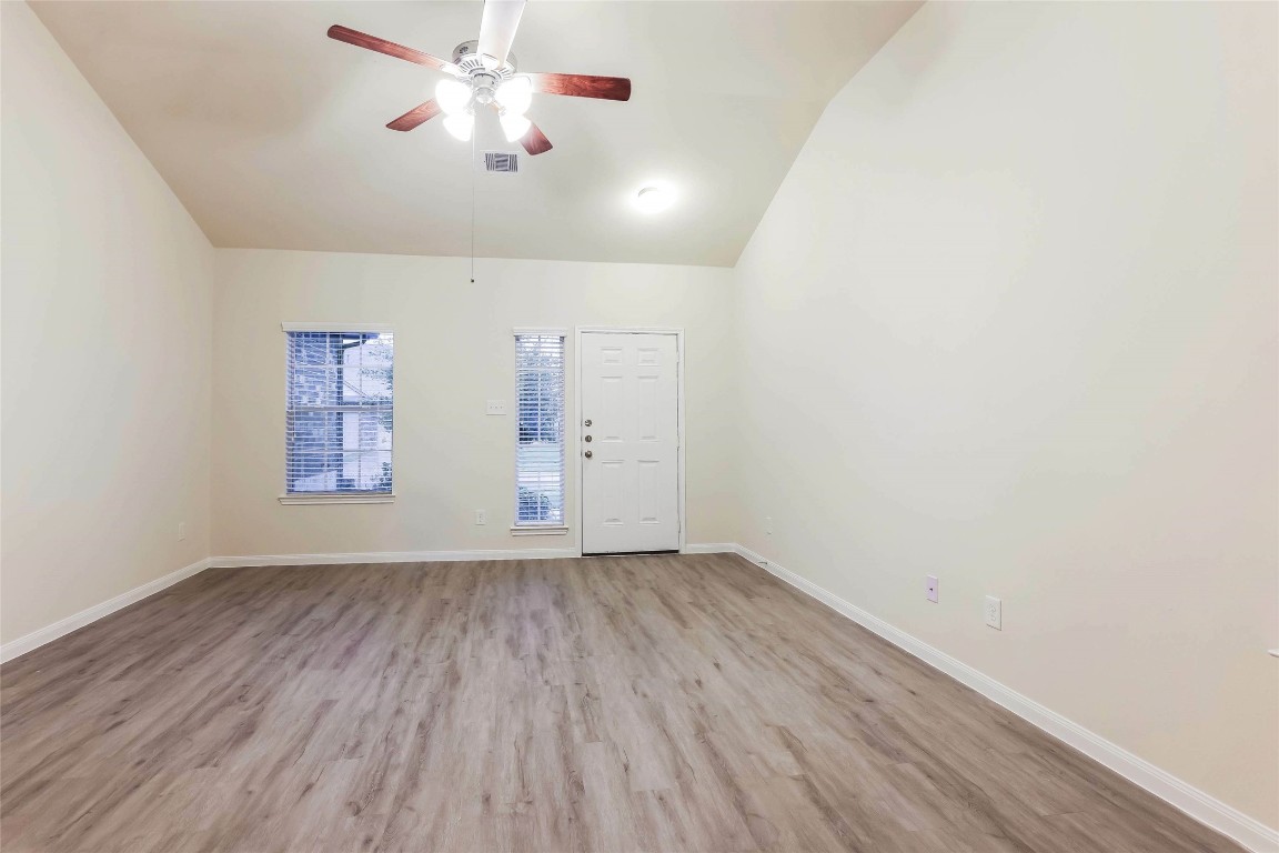 12330 Roy Mix Bohn Lane Houston, TX 77044 - Photo 8 of 17 wooden floor in an empty room with a window