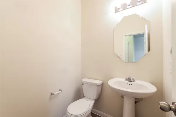 a bathroom with a granite countertop sink a toilet and shower