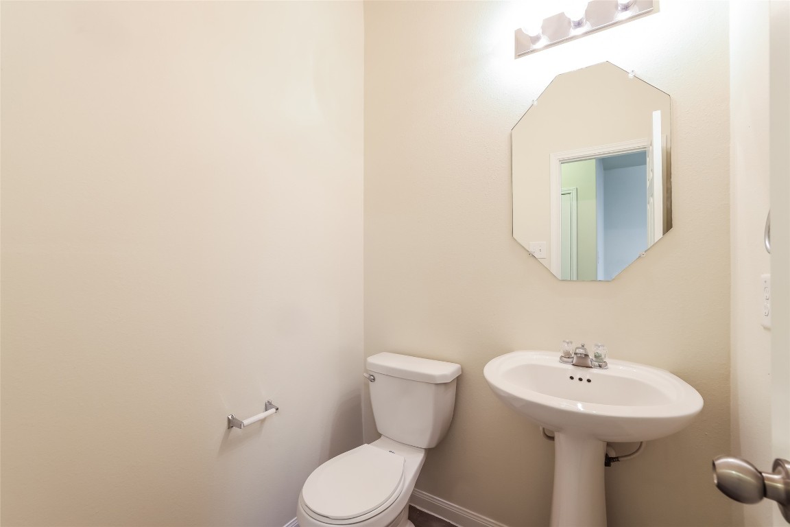 12330 Roy Mix Bohn Lane Houston, TX 77044 - Photo 9 of 17 a bathroom with a toilet a sink and mirror