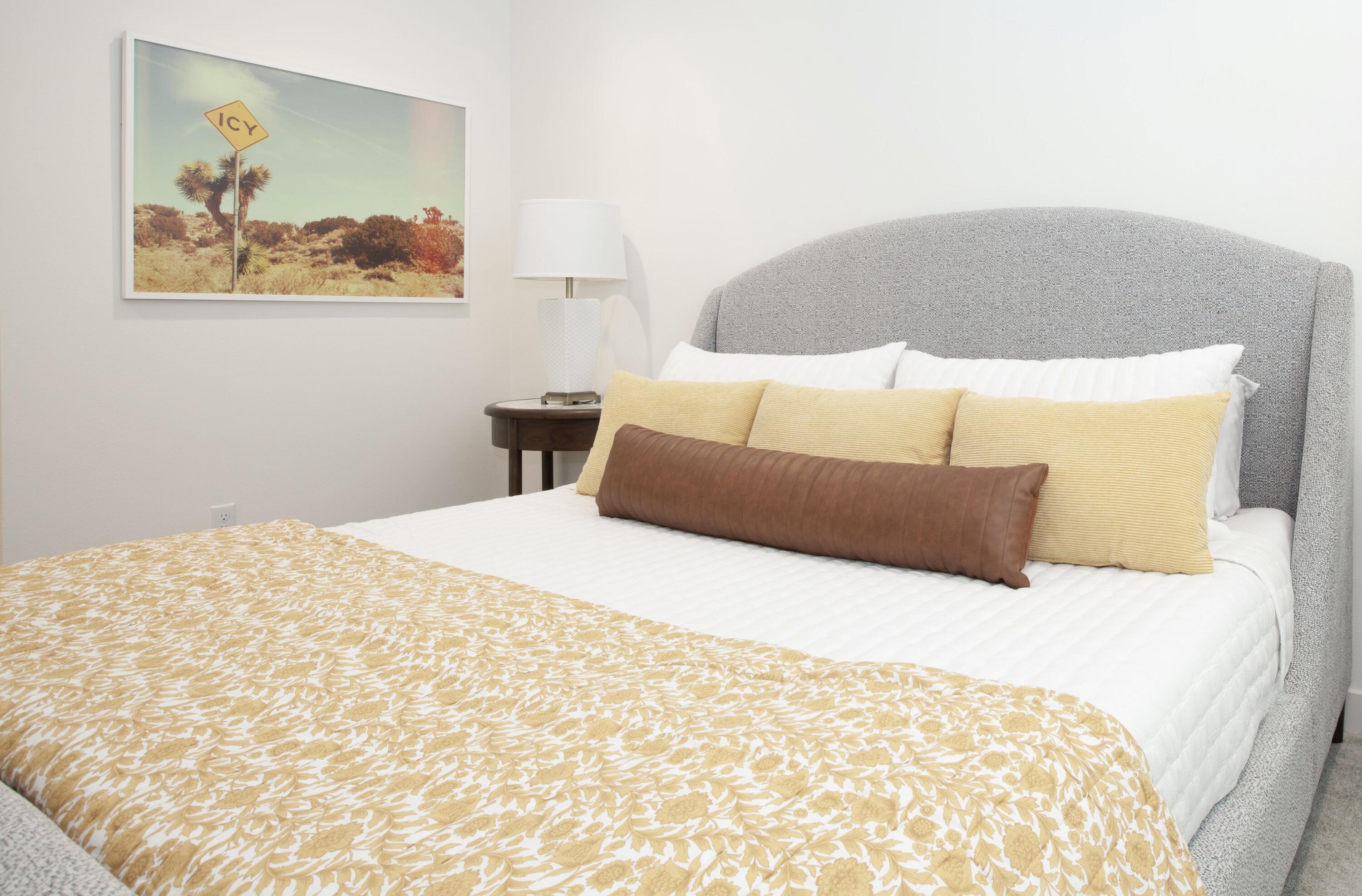 80215 Whisper Rock Way La Quinta, CA 92253 - Photo 14 of 63 a bedroom with a bed and a painting on the wall