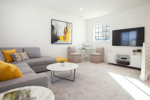 a bedroom with a bed and a painting on the wall