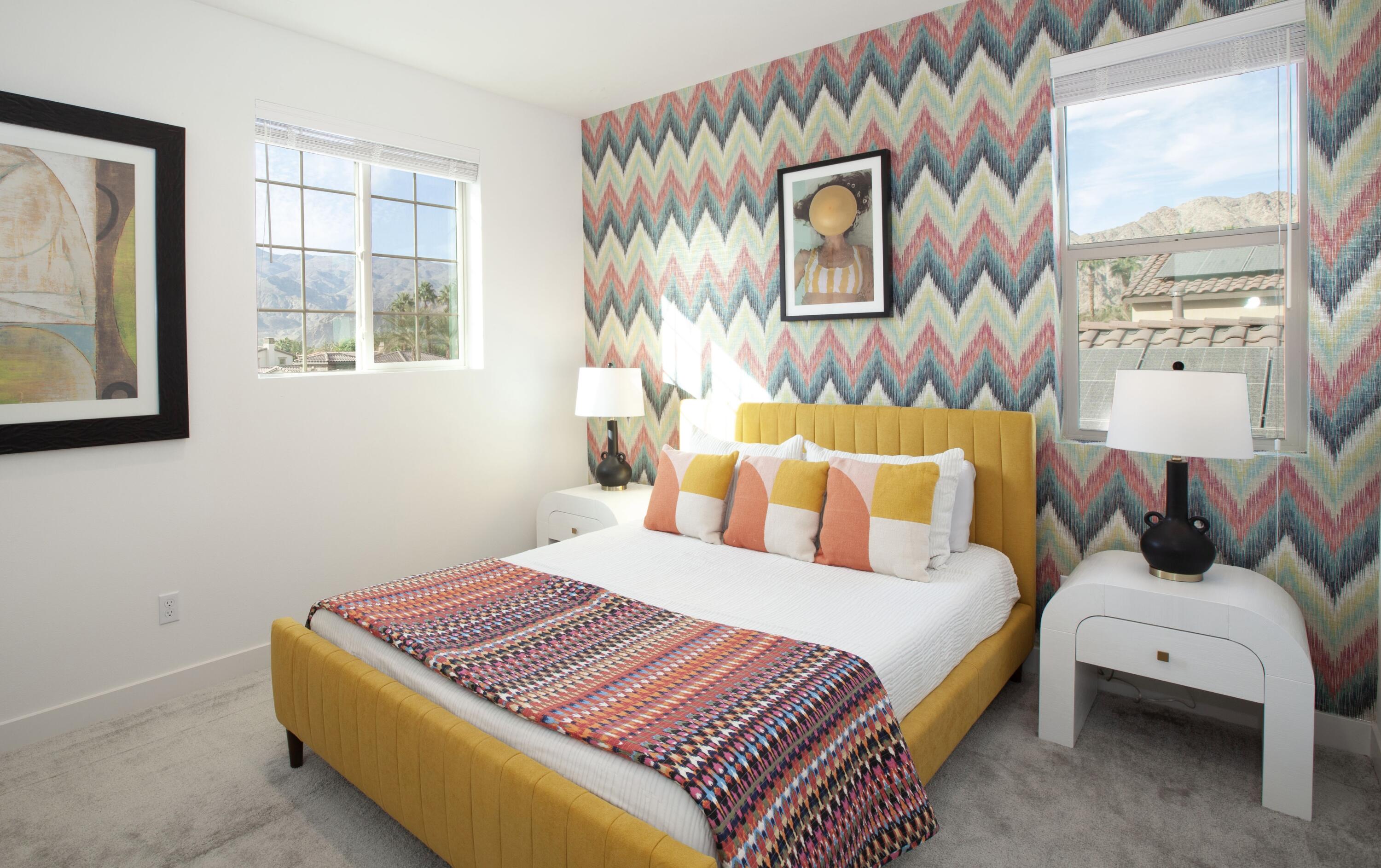 80215 Whisper Rock Way La Quinta, CA 92253 - Photo 27 of 63 a bedroom with a bed and a painting on the wall