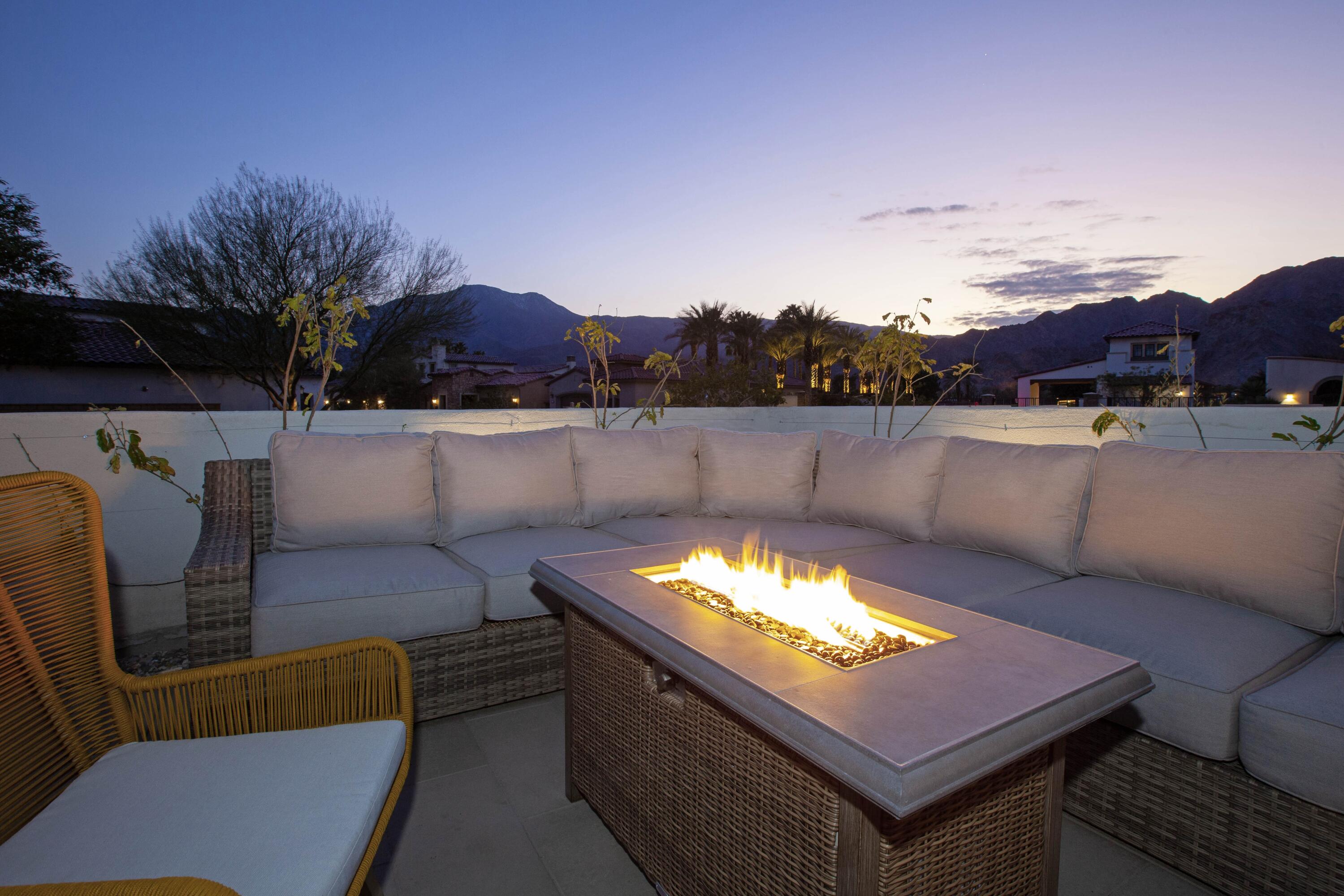 80215 Whisper Rock Way La Quinta, CA 92253 - Photo 48 of 63 a outdoor sitting area with furniture and a fireplace