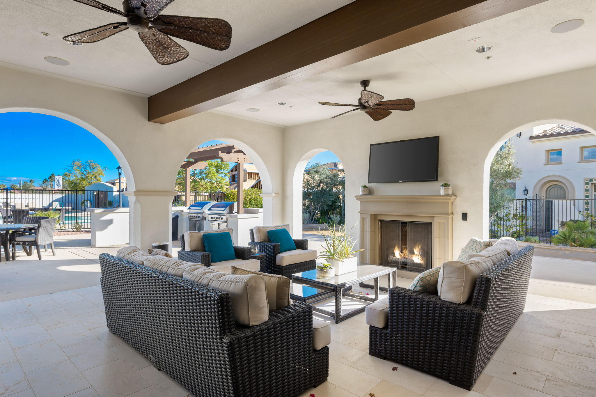 80215 Whisper Rock Way La Quinta, CA 92253 - Photo 55 of 63 a living room with furniture a fireplace and a ceiling fan
