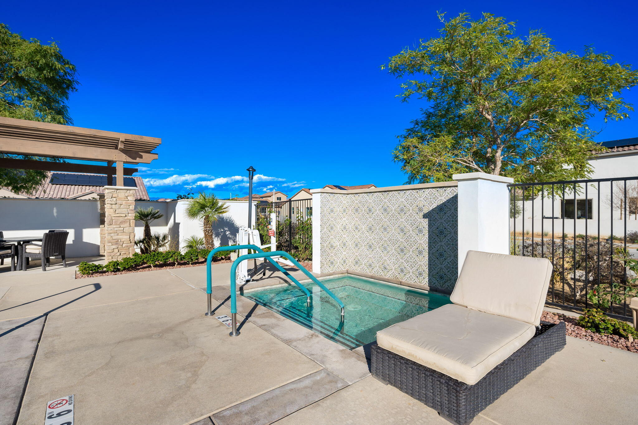 80215 Whisper Rock Way La Quinta, CA 92253 - Photo 60 of 63 a view of a patio with a table and chairs under an umbrella with potted plants