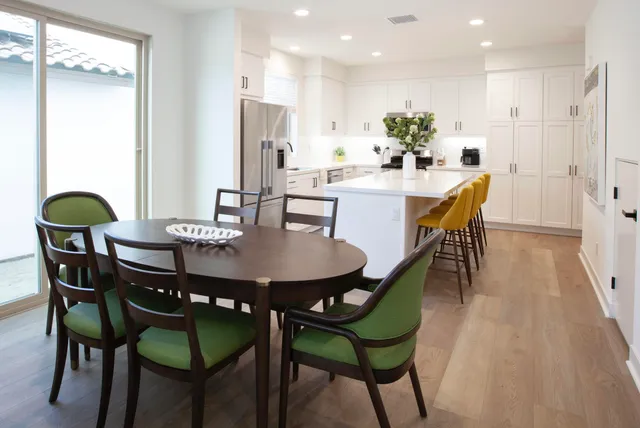 a dining room with furniture and wooden floor