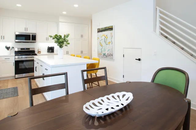 a kitchen with white cabinets and appliances