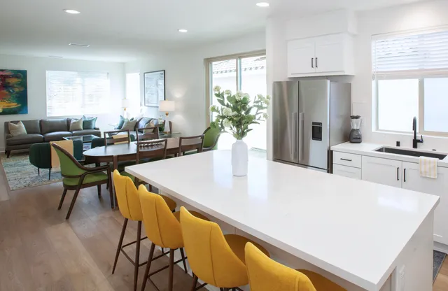 a bedroom with a bed and painting on the wall