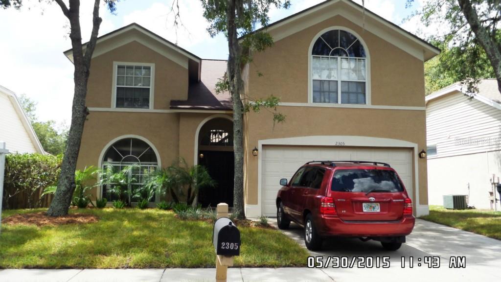 2305 Lyncrest Court Valrico, FL 33596 - Photo 1 of 1 a front view of a house with a garden