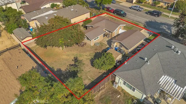 an aerial view of multiple houses with yard