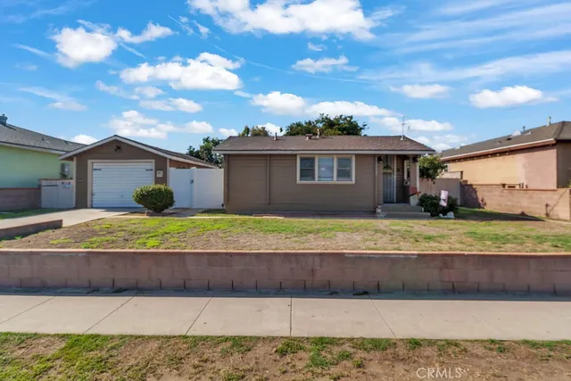 a backyard of a house with table and sofas