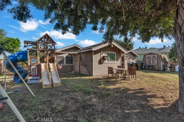 a view of a backyard with large tree