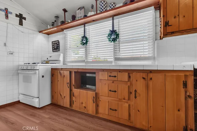 a kitchen with stainless steel appliances granite countertop wooden cabinets and a sink