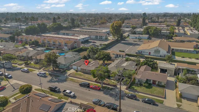 an aerial view of residential houses with outdoor space and street view
