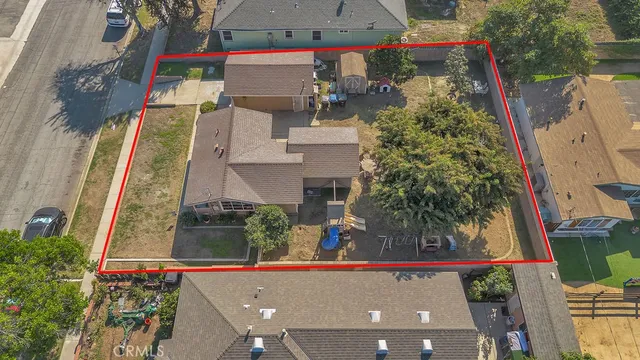 an aerial view of a houses with street