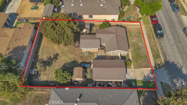 an aerial view of residential houses and car parked on street side