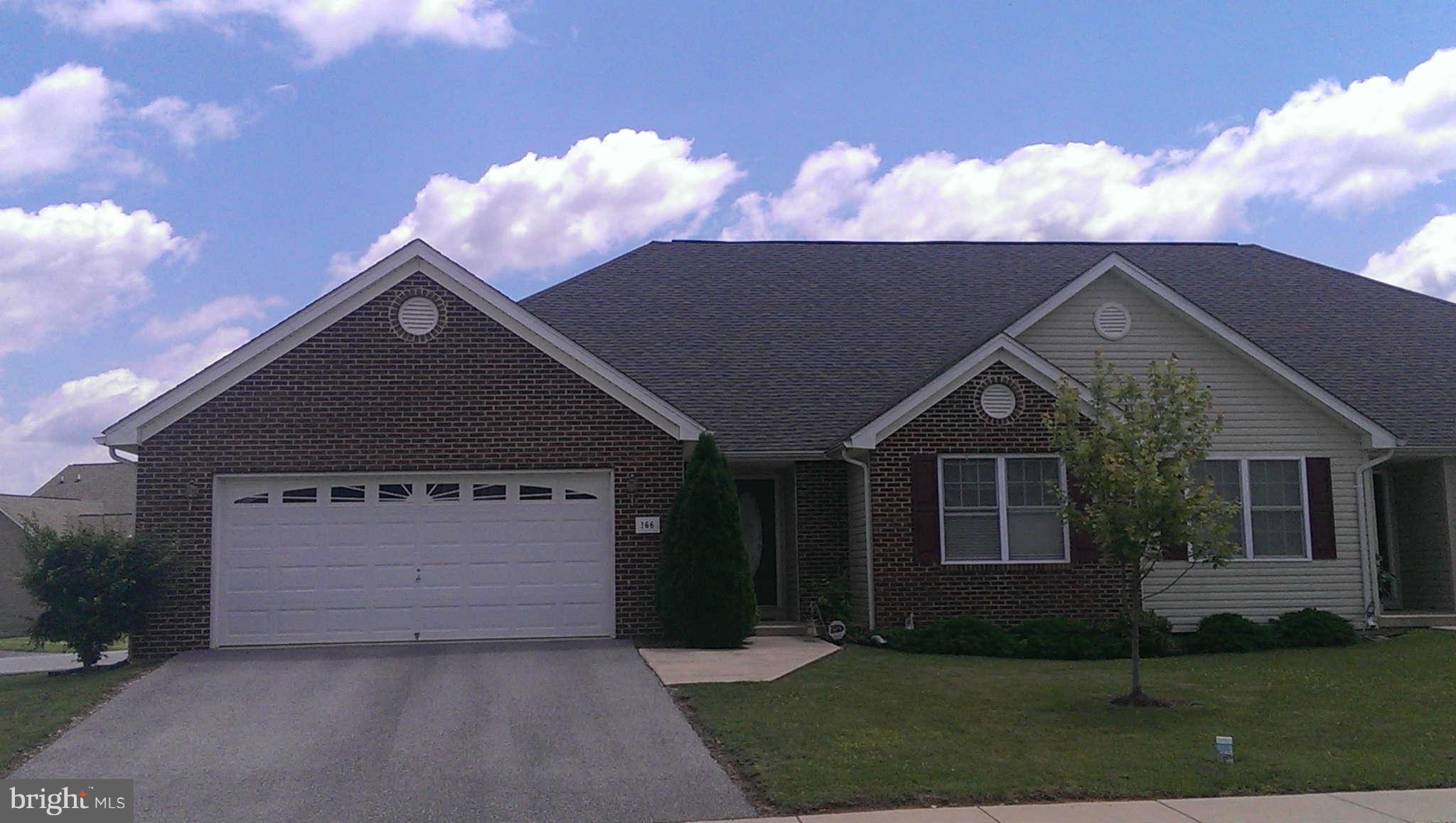 166 Peter Rabbit Drive Ranson, WV 25438 - Photo 1 of 14 a front view of a house with a yard and garage