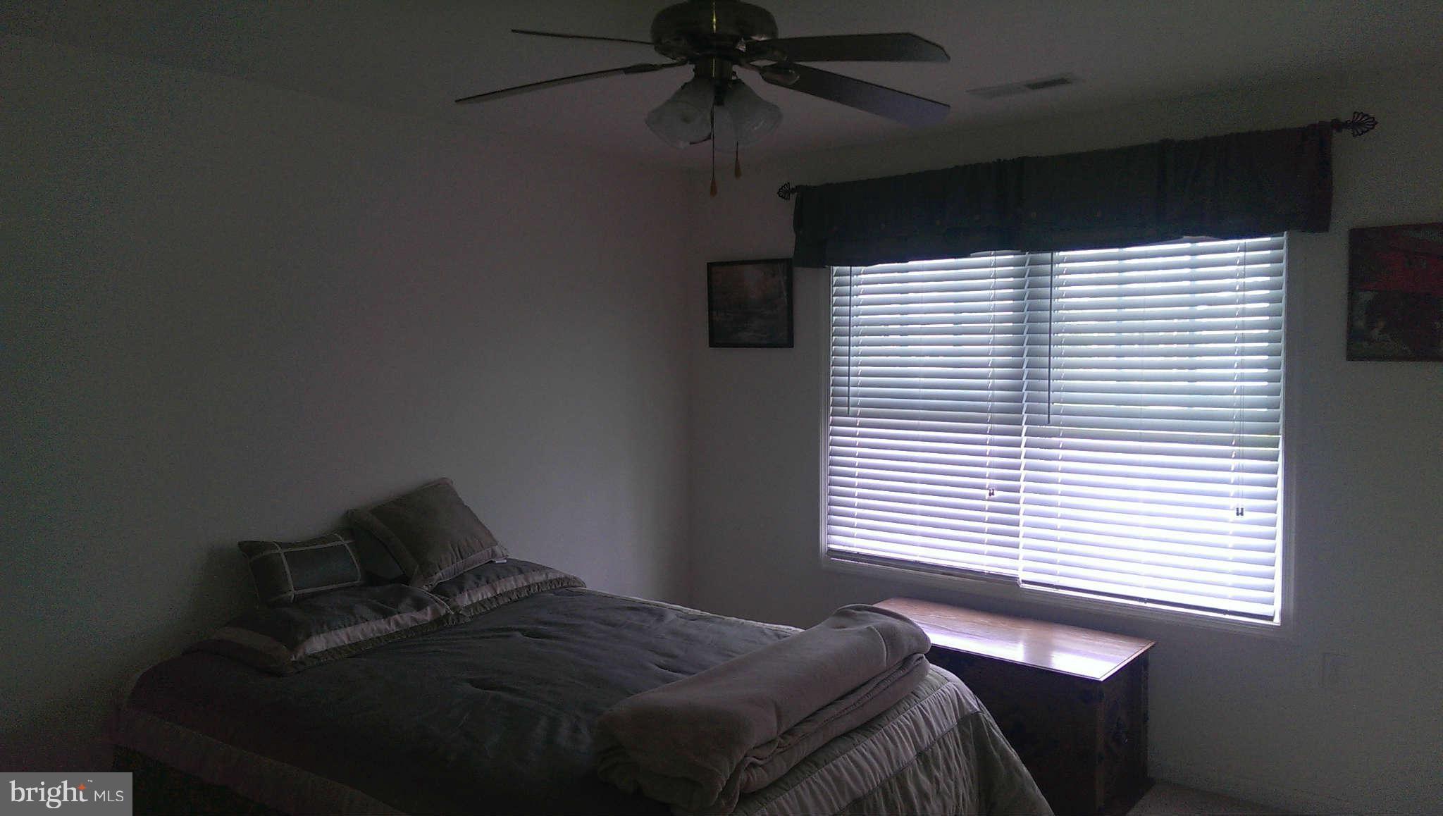 166 Peter Rabbit Drive Ranson, WV 25438 - Photo 11 of 14 a bedroom with a bed and a window