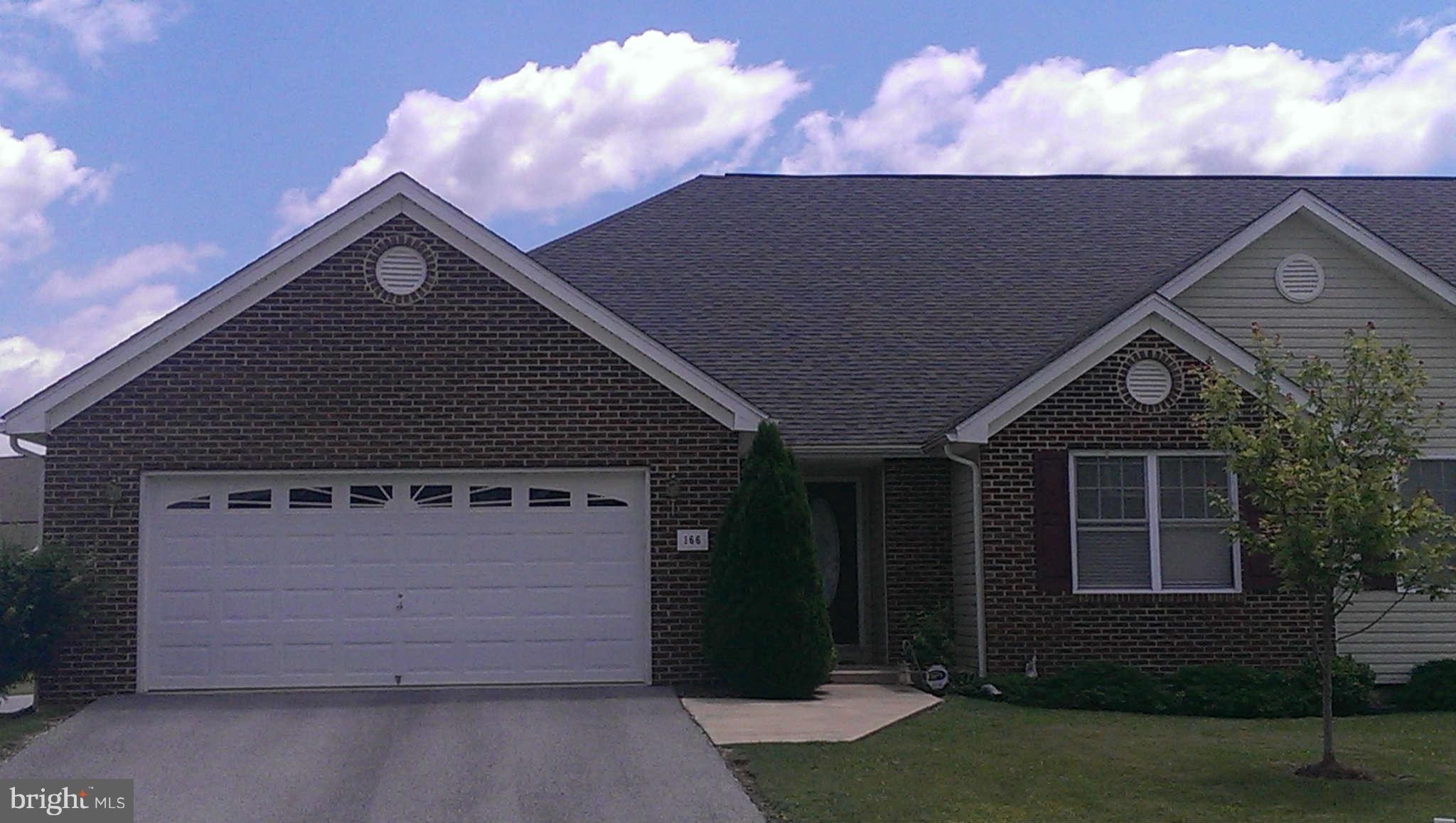 166 Peter Rabbit Drive Ranson, WV 25438 - Photo 13 of 14 a front view of a house with a yard and garage