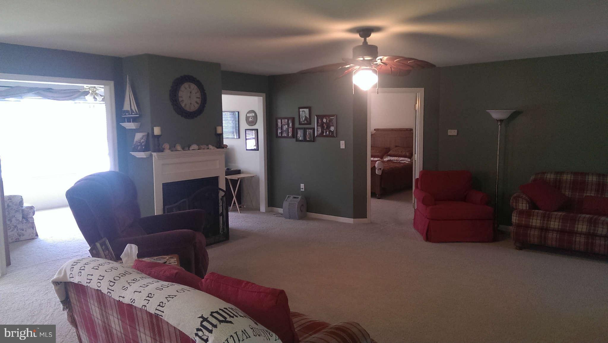 166 Peter Rabbit Drive Ranson, WV 25438 - Photo 8 of 14 a living room with furniture and a wooden floor