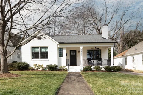 a view of a house with backyard porch and sitting area