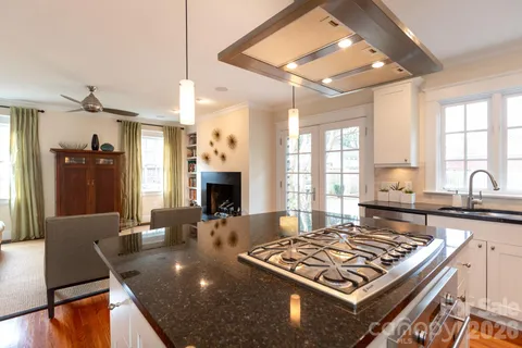 a kitchen with a stove and white cabinets